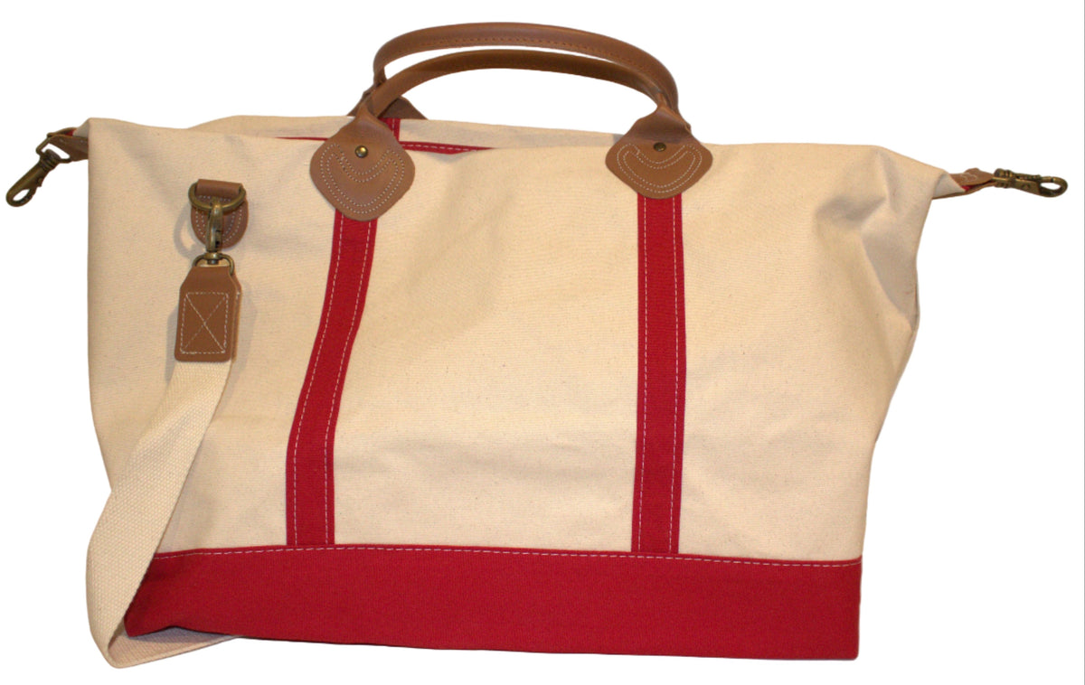 White handbag with red accents and brown handles on a white background