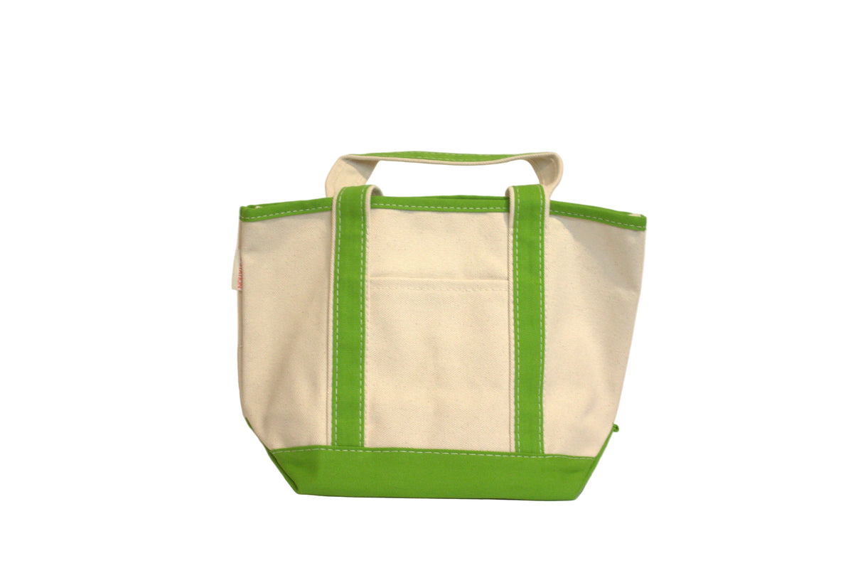 Beige tote bag with green edges on a light gray background