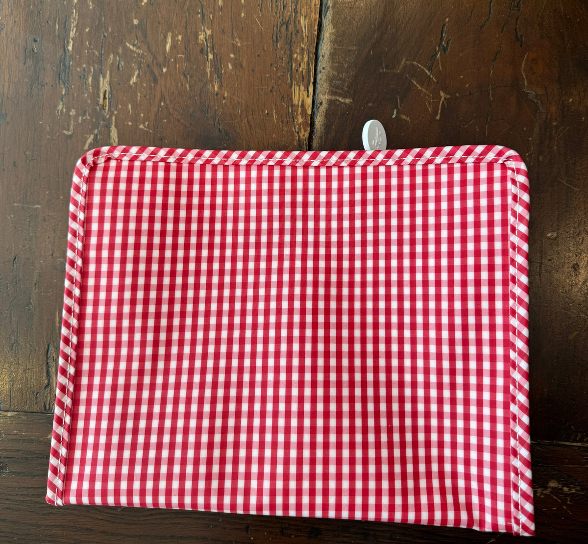 Red and white TRVL Design Cosmetic Pouch