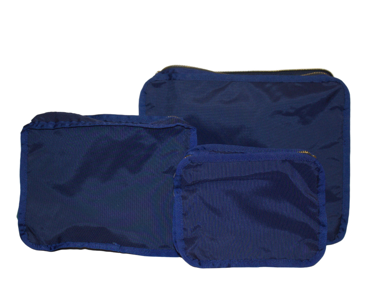 Three blue fabric bags of different sizes on a white background